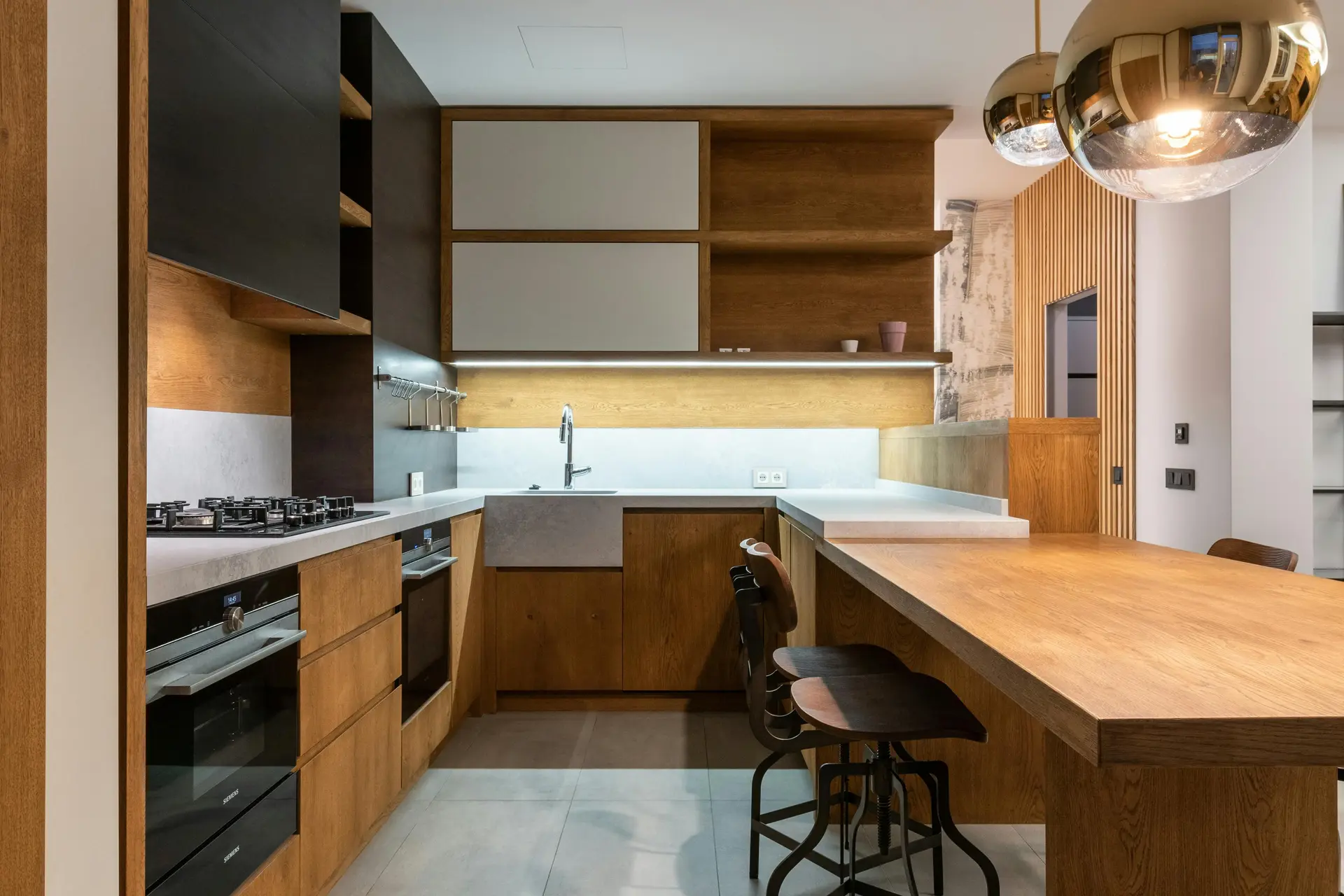 Dark oak kitchen with island and integrated appliances