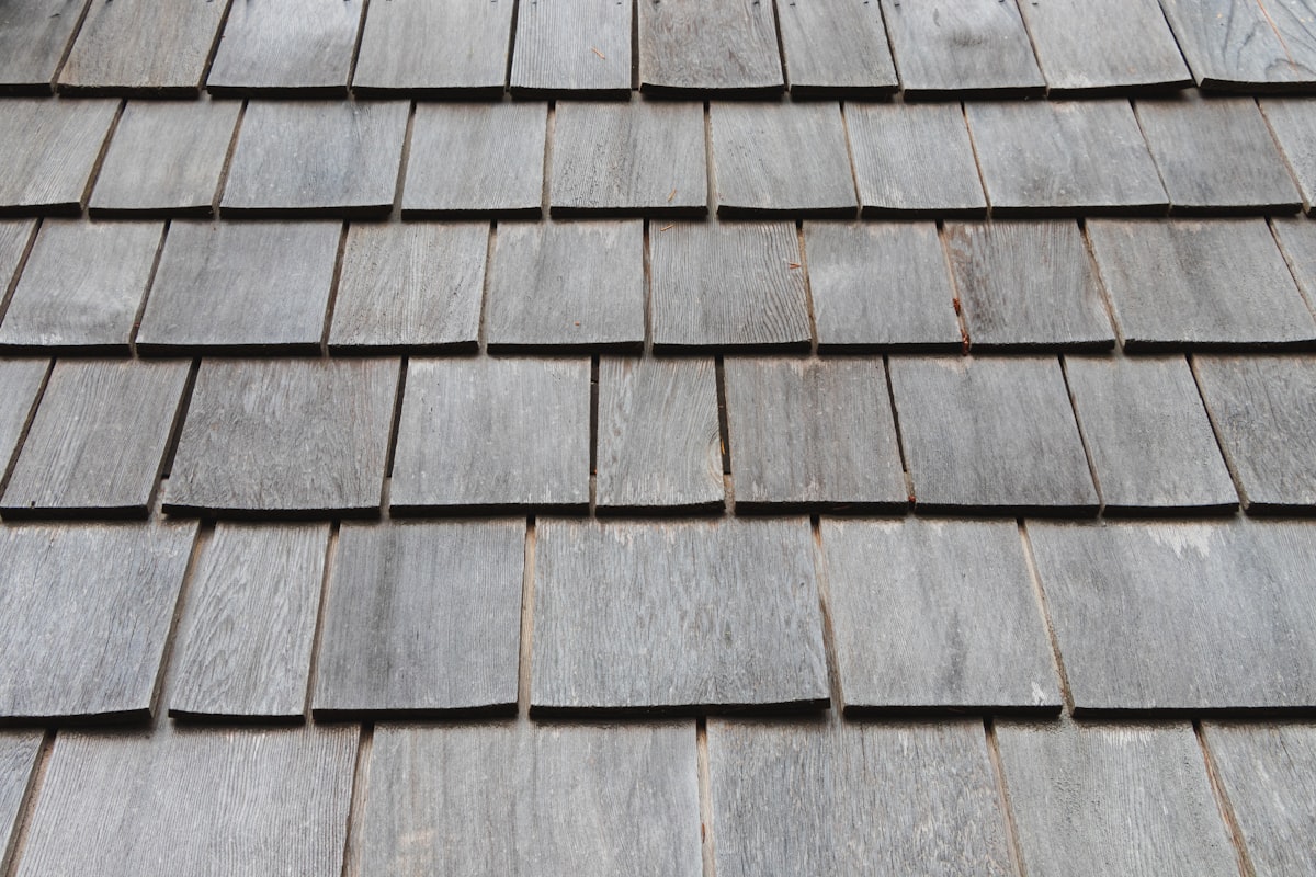 Close-up of weathered timber shingles on a steep-pitched roof
