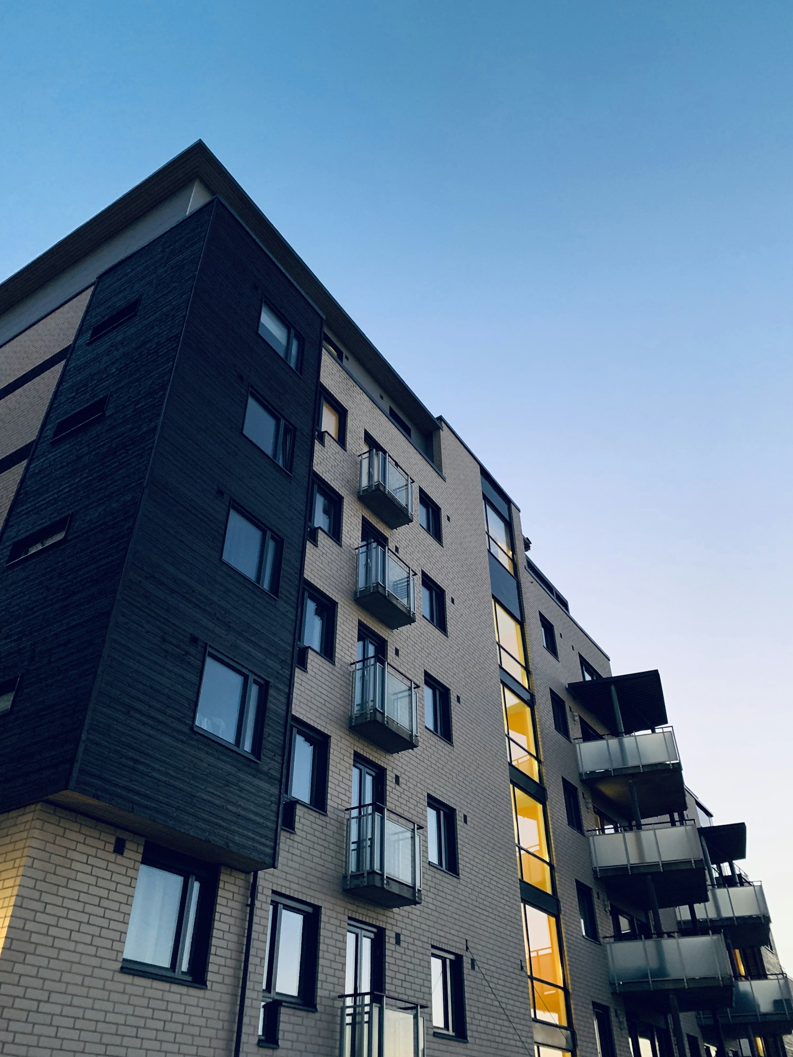 Modern flat-roofed home under construction at dusk