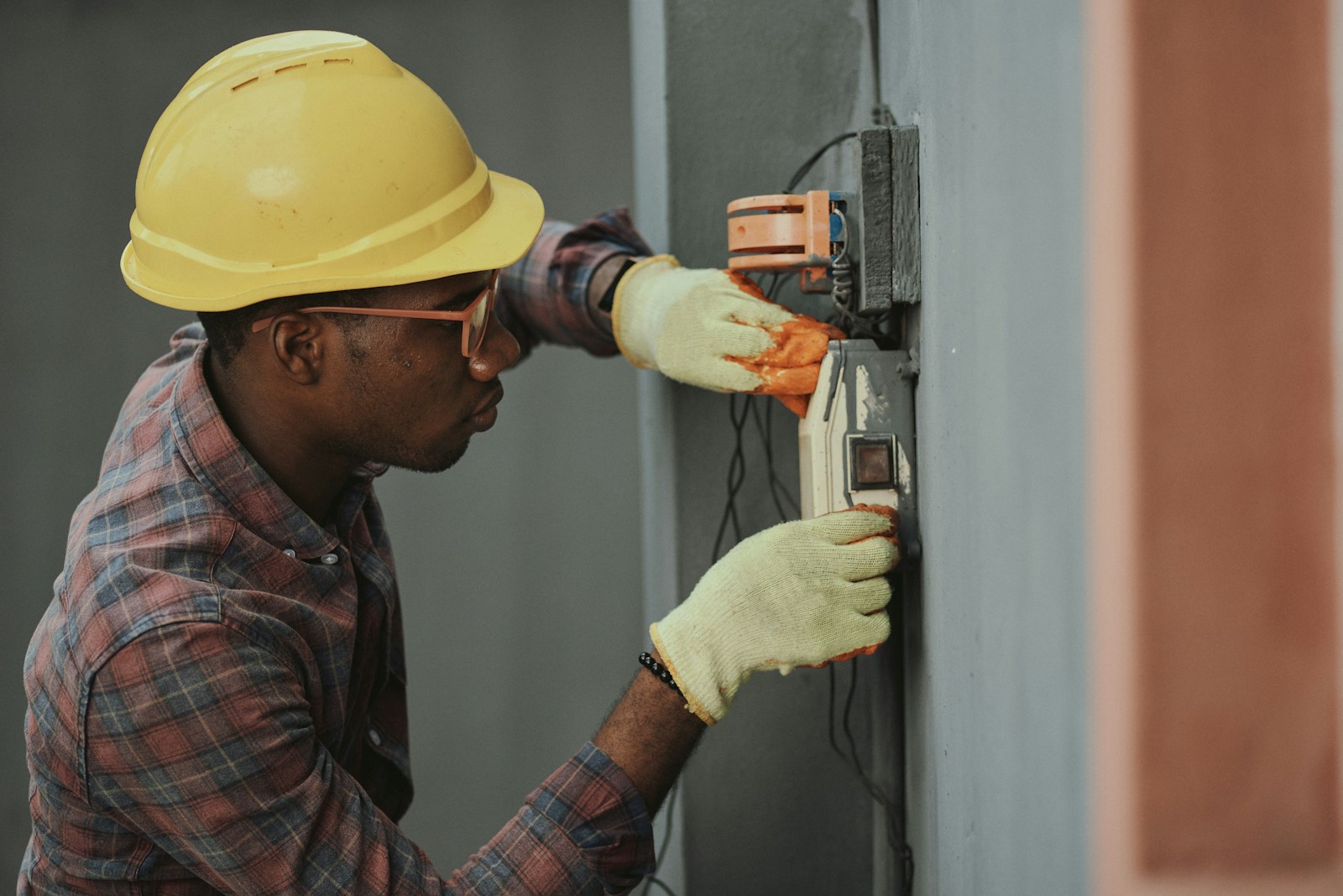 Electrician working on a circuit board with precision tools